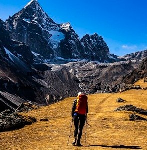 women-trekking-grass
